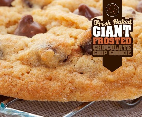 fresh baked giant frosted chocolate chip cookie